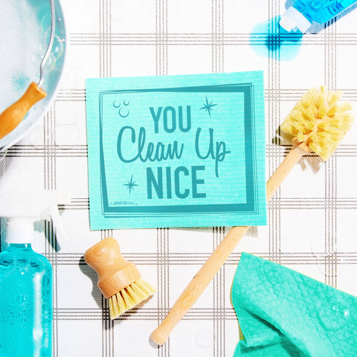 Teal rectangular compostable cleaning sponge with you clean up nice printed in dark teal script and star accents