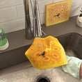 Load image into Gallery viewer, A yellow swedish dishcloth washed under running water in a stainless steel kitchen sink. A hand wearing a light green glove holds the scrubber.
