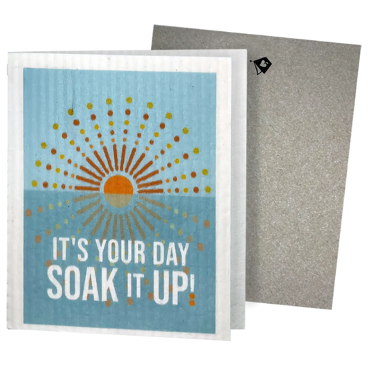 Greeting Clards® with sun design and text 'It's your day, soak it up!' on a blue background with envelope. Greetings that turn into reusable cleaning cloths. Soakitup.shop