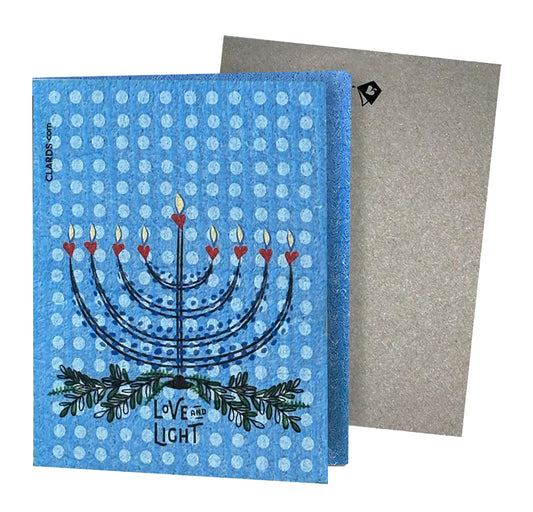 Blue textured hanukkah-themed reusable cleaning cloth with menorah design and love and light label for eco greeting card