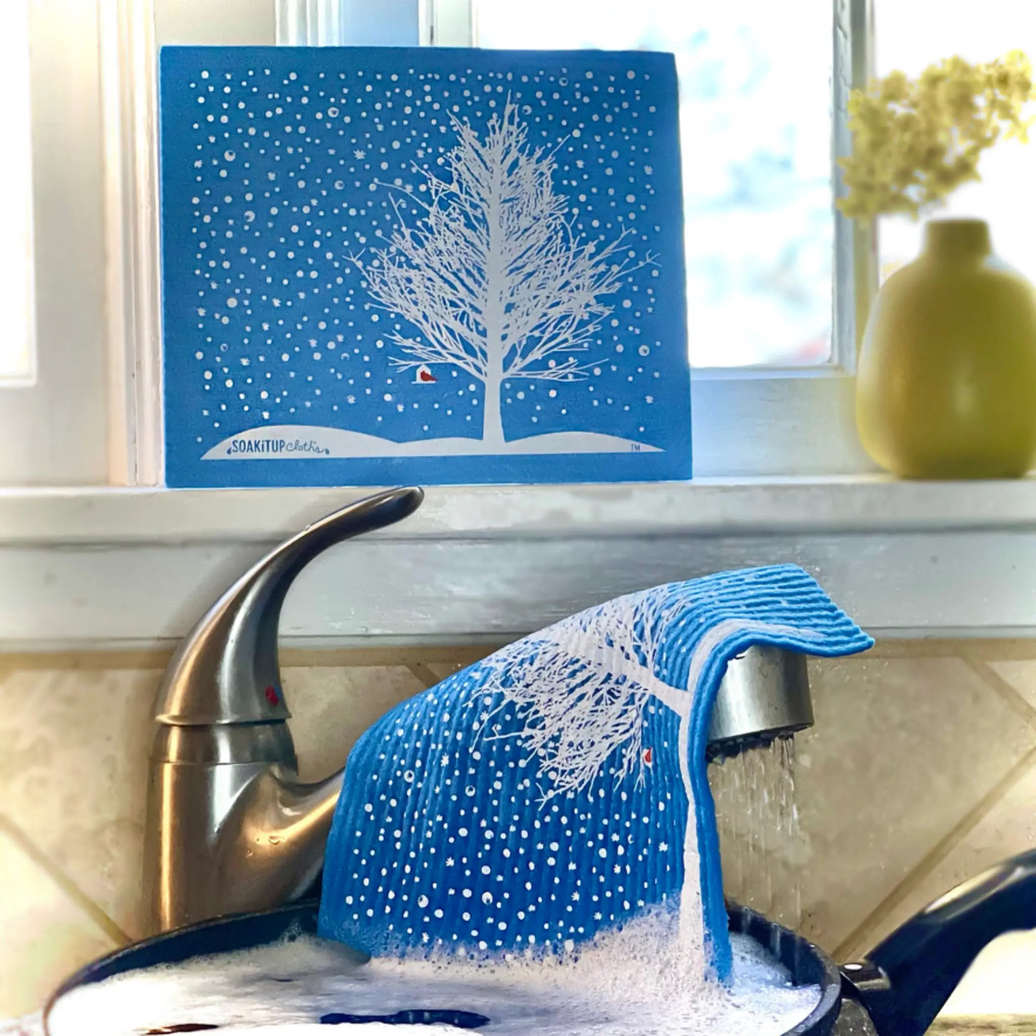 Blue snowy tree red cardinal swedish dishcloth made of textured eco-friendly fabric for cleaning tasks