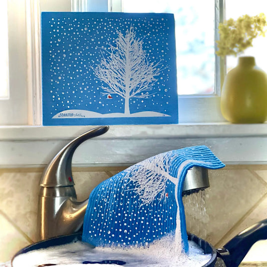 Blue snowy tree red cardinal swedish dishcloth made of textured eco-friendly fabric for cleaning tasks