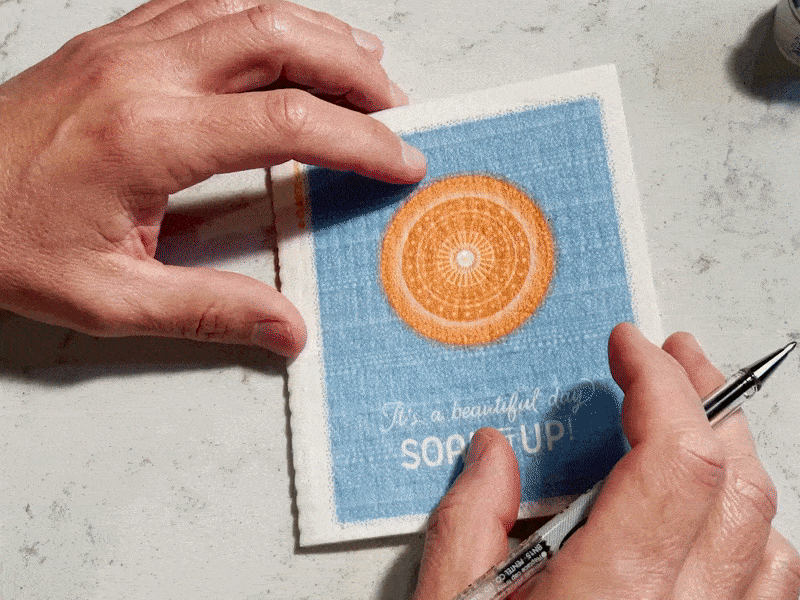 Blue textured cloth napkin with orange mandala design and white text perfect reusable cleaning cloths holiday greeting