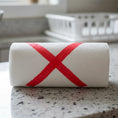 Load image into Gallery viewer, A white paper towel roll with a red x used as eco holiday greeting reusable cleaning cloths from soak it up cards
