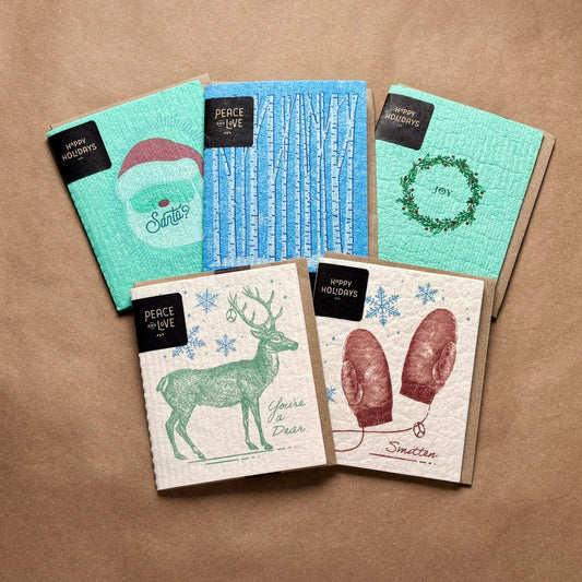 Set of five holiday cards with festive santa deer and mittens designs on textured paper for joy rider cloth use