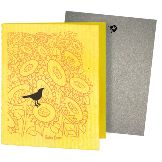 Bright yellow swedish sponge cloth with status crow greeting design featuring crow on sunflowers for sustainable cleaning